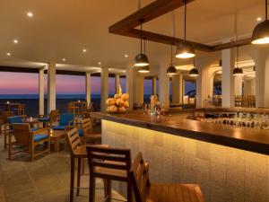a restaurant with a bar with a view of the ocean at Jetwing Sea in Negombo