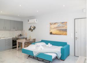 a bedroom with a blue bed and a kitchen at Rhea Central Luxury Apartment in Samos