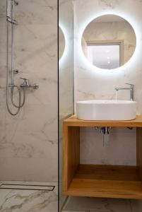 a bathroom with a sink and a shower at Rhea Central Luxury Apartment in Samos +22 photos