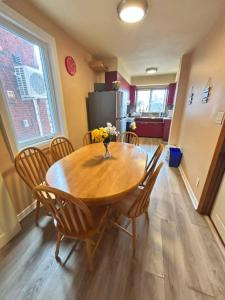 a dining room with a wooden table and chairs at TORONTO Midtown HomeHaven in Toronto +7 photos