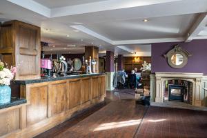 a bar in a pub with a fireplace at Honest Lawyer Hotel in Durham