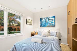 a bedroom with a bed and a window at The Springs in Point Lonsdale