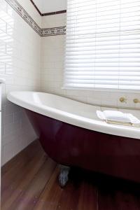 a large red tub in a bathroom with a window at QPO Queenscliff in Queenscliff +13 photos