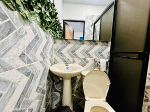 a bathroom with a toilet and a sink at Apartahotel Dazuwi in Doradal +70 photos