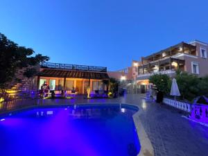 a swimming pool in front of a building at night at Riad Dar Salam in Agadir