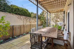 a wooden table and chairs on a patio at Willos in Queenscliff
