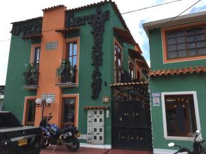 a motorcycle parked in front of a building at ApartaHotel Tierras Amazonicas in Leticia