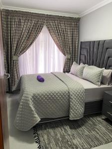 a bedroom with a large bed with a large window at Smileys accomodation in Standerton