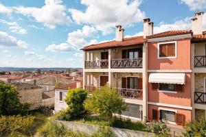 an apartment building with a view of a city at Petra Afytos holiday in Afitos