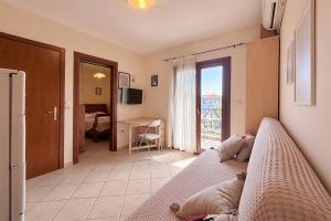 a room with a bed and a living room at Petra Afytos holiday in Afitos +5 photos
