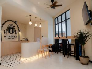 a kitchen and living room with a table and chairs at Hotel Mirda Puncak Alam in Bandar Puncak Alam