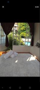 a bedroom with a bed and a large window at Casa Sauces in Tepoztlán