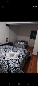 a bedroom with a bed with a black and white blanket at Casa Sauces in Tepoztlán