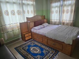 a bedroom with a bed and a window with curtains at Jhapali Hotel and lodge in Simra +7 photos