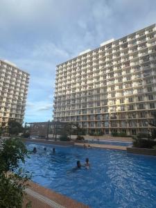a large swimming pool in front of a large building at Arastar Escape - Relax and Unwind- NetFlix - Fast Wifi - Pool Access in Suba