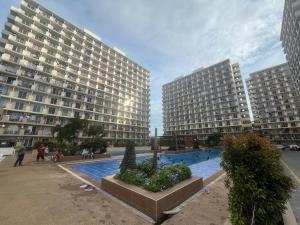 two large buildings with a pool in the middle at Arastar Escape - Relax and Unwind- NetFlix - Fast Wifi - Pool Access in Suba