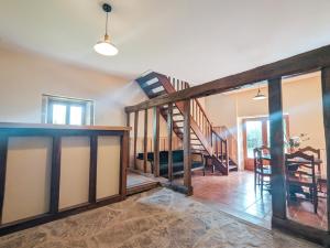 a living room with a wooden staircase in a house at Gite 15 pers tout compris Les Lucioles in Crevant