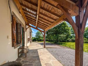 an external view of a building with a wooden roof at Gite 15 pers tout compris Les Lucioles in Crevant