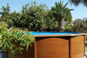 a hot tub in a garden with trees at Luxury Villa Villa Serenity Kymi in Paralia Kimis