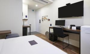 a room with a desk with a computer and a monitor at JustSleep Namyangju Dasan in Namyangju