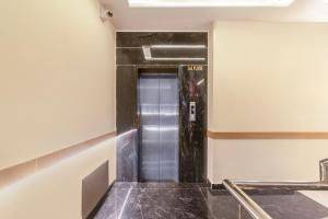 a elevator in a hallway of a building at Treebo Indus in Jaipur +32 photos