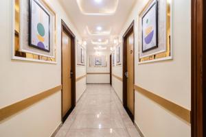 a corridor in a building with paintings on the walls at Treebo Indus in Jaipur