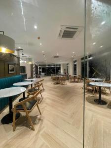 a restaurant with tables and chairs in a room at Azure North MiCasa in San Fernando