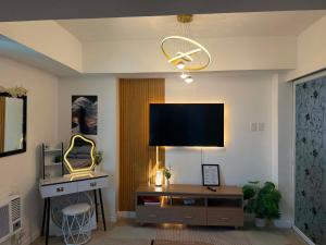a living room with a flat screen tv on a wall at Azure North MiCasa in San Fernando