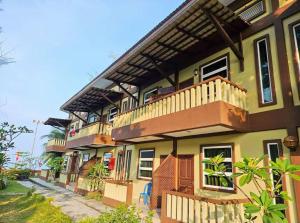 a large house with a balcony on top of it at Delta Chenang Resort in Pantai Cenang