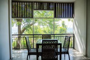 a table and chairs on a balcony with a view at seaview apartment in Honiara