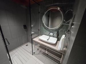 a bathroom with a sink and a mirror at Weekend Retreat- Hotel & Spa in Kurseong +8 photos