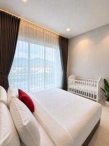 a bedroom with a large bed and a large window at The Garnet Light Pool Villa Aonang-3BR Private Pool Villa in Ao Nang Beach