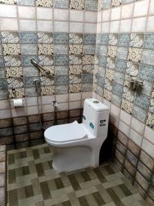 a bathroom with a toilet and a shower at Cherys Bunglow Homestay- Rooms in Thiruvalla +50 photos