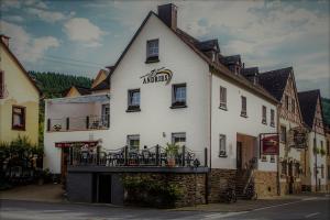 a white building with a balcony on the side of it at Pension Andries in Ernst
