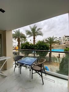 a table and chairs on a balcony with a view at Jasmine Resort Complex in Sharm El Sheikh