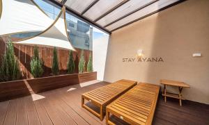 a balcony with a bench and a sign on the wall at HOTEL STAY AYANA DAEJEON in Daejeon