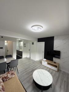 a living room with a couch and a table at Aqua apartment in Gornji Ribnik