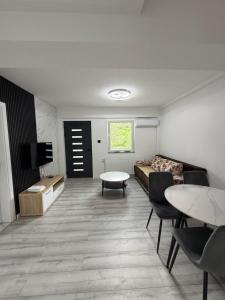 a living room with a couch and a table at Aqua apartment in Gornji Ribnik