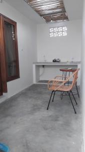 a desk and a chair in a room at Datang Kemari Bungalow in Gili Islands