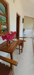a room with a wooden bench with flowers on it at Hilias Retreat in Palolem