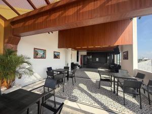 a patio with tables and chairs and a fireplace at Le Dung Hotel in Tam Kỳ