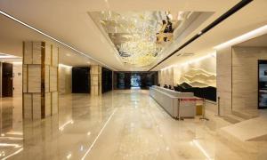 a lobby of a building with a chandelier at Jeonju Tourist Hotel kkotsim in Jeonju