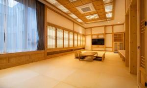 a large room with a table and a window at Jeonju Tourist Hotel kkotsim in Jeonju