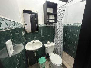 a small bathroom with a toilet and a sink at Misha Home Nro 732 in Puerto Ayora +13 photos