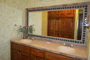a bathroom with two sinks and a large mirror at Palacio del Mar Rocky Point by Castaways in Puerto Peñasco