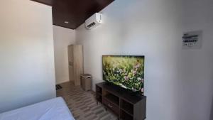 a living room with a flat screen tv on a wall at Isla Del Mar Villas in Panglao Island
