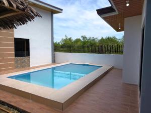 a swimming pool in the backyard of a house at Isla Del Mar Villas in Panglao Island