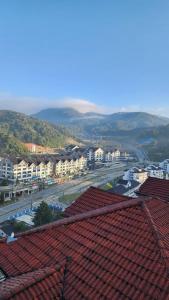 a view of a city with buildings and roofs at The Gladiator Homstay in Brinchang