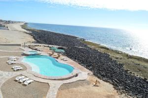 an aerial view of a resort with a swimming pool and the ocean at Palacio del Mar Rocky Point by Castaways in Puerto Peñasco