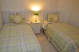 Ένα ή περισσότερα κρεβάτια σε δωμάτιο στο Palacio del Mar Rocky Point by Castaways